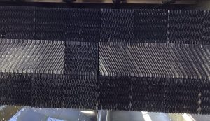 Cooling tower fill pack inside the tower showing structured fill material that increases water surface area to improve heat transfer and cooling efficiency.