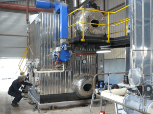 Technician dismantling an industrial boiler to investigate and repair an internal equipment issue affecting boiler operation and performance.