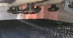 Cooling tower spray nozzles mounted on the distribution header evenly spraying water over the fill pack to maximise heat transfer and cooling efficiency.