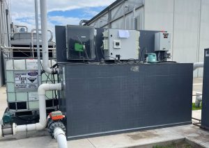 Above-ground wastewater treatment system with controller-based automatic chemical dosing and an IBC chemical tank used to manage wastewater pH and discharge compliance.